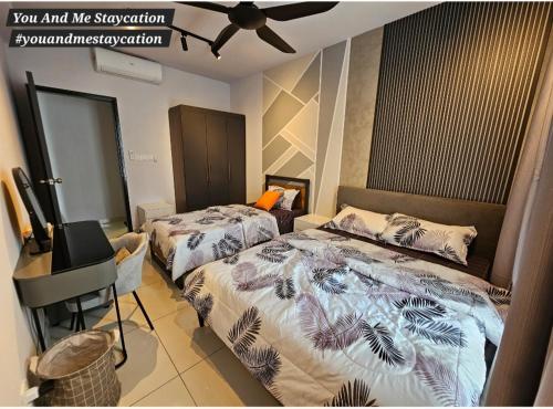 a bedroom with two beds and a ceiling fan at Luge Gardens You and Me Staycation Gaia Residences in Rawang