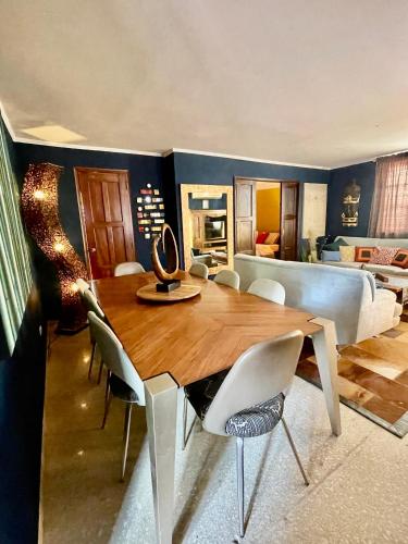a dining room with a table and chairs and a bedroom at ORHO Hotel Boutique 15 minuts PTY Airport free shuttle in Tocumen