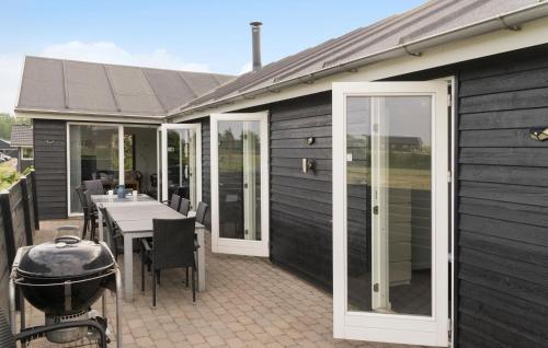 a patio with a grill and a table with a grill at Holiday Home Flovt Havevej V in Flovt