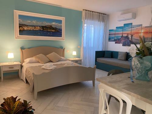 a bedroom with a bed and a couch at B&B La Lingua in Procida