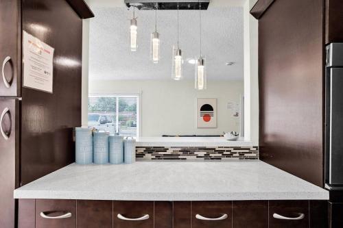 a kitchen with a counter with blue containers on it at Ventur Oasis Lux Hollywood Private Pool Retreat in Hollywood