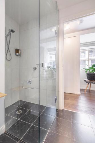 a bathroom with a shower with a glass door at VAQUAY Tribeca in Melbourne CBD in Melbourne