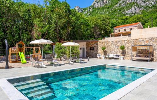 a swimming pool with a patio and a house at Awesome Home In Bribir With Jacuzzi in Bribir