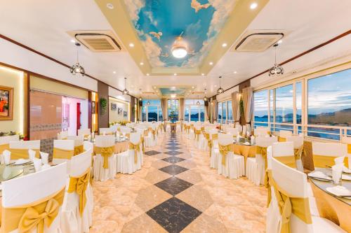 a banquet hall with white tables and chairs at Central in Town - Sea Veiw -Thao Minh New Star Hotel in Cat Ba