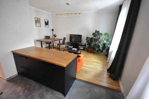 an office with a desk and a tv in a room at Apartamenty Basztowa in Świdnica