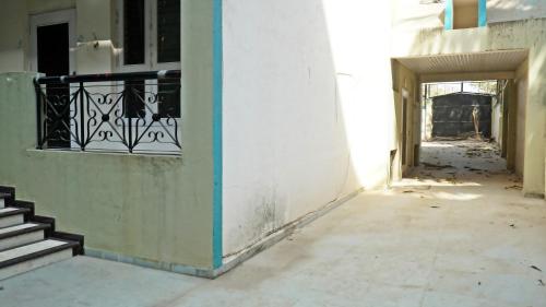 an empty hallway of a building with a staircase at NANDINI BUNGLOw in Thane