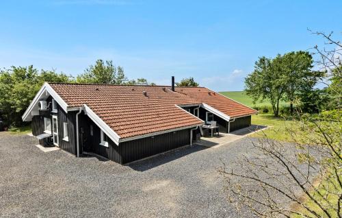 a house with a brown roof on a lot at Lovely Home In Sydals With Sauna in Høruphav