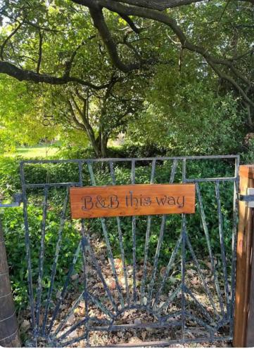 a gate with a sign that says back this way at Wattle Creek Studio with Breakfast Basket in Amberley