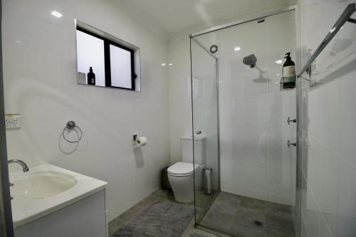 a bathroom with a shower and a sink and a toilet at Ally’s Umina Oasis, pet-friendly spa coastal oasis in Umina