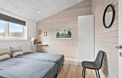 a bedroom with a bed and a chair in it at Cozy Home In Faaborg With Wifi in Fåborg