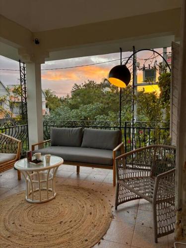 a living room with a couch and chairs on a balcony at Apartment with private rooftop 450 m from the beach in Flic-en-Flac