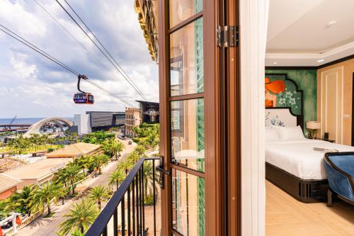 a bedroom with a bed and a view of the ocean at Hoàng Hôn Tím Boutique Hotel in Phú Quốc