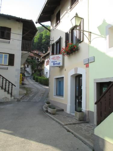 a building with a sign on the side of it at Studio Brnat in Kobarid