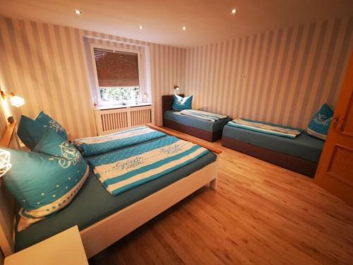 a large room with two beds and a window at Holiday apartment Gitti Ueckermünde in Ueckermünde