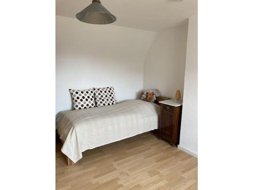 a small bedroom with a bed and a wooden floor at Haus FeLiSi Comfortable holiday residence in Bad Grund