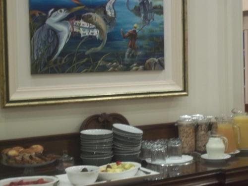 a table with plates of food and a painting at St Judes B&B in Galway