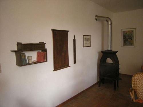 a room with a wood stove and a chair at "Ancien Cafe" with roof terrace and balcony in Camplong-dʼAude