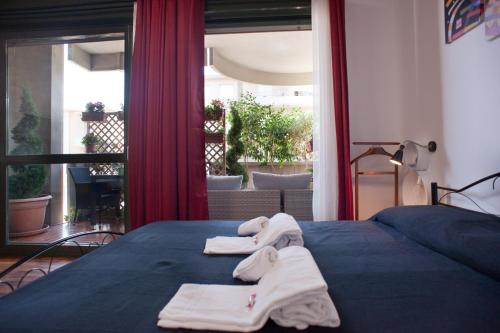 a bedroom with a bed with towels on it at Visit Cagliari in Cagliari