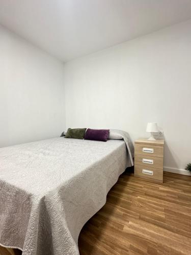 a bedroom with a bed and a night stand at The Valencia Stop in Valencia