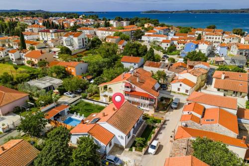 an aerial view of a town with orange roofs at House with private pool 150 m from sea! in Fažana