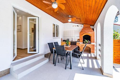 a kitchen and dining room with a wooden ceiling at House with private pool 150 m from sea! in Fažana