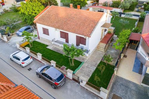 an aerial view of a house with cars parked in front at House with private pool 150 m from sea! in Fažana