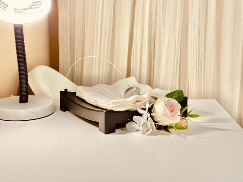 a hospital bed with a bouquet of flowers on a table at Scorpion Hiuse Langley ROOM B in Langley