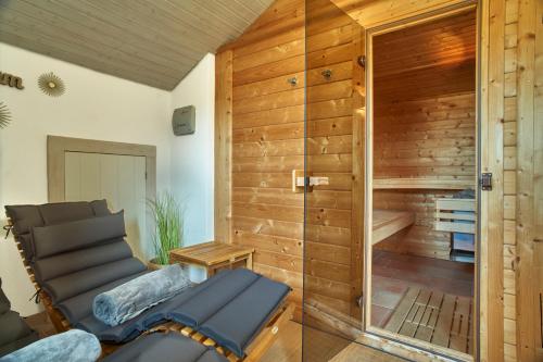 a sauna with a bench in a room with wooden walls at Pension Kilger in Mauth