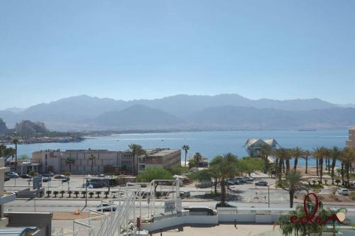 a view of a city with a body of water at סוויטה עם מרפסת ליד הים -By Edomlux in Eilat