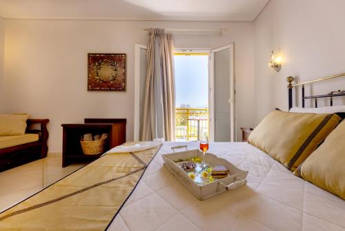 um quarto com uma cama com uma bandeja de comida em Aegean Palace em Plaka