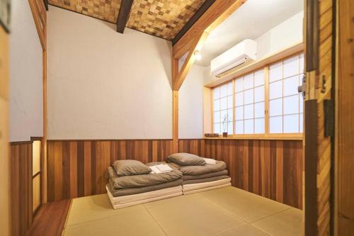 a room with a couch in the middle of it at Nonki in Osaka