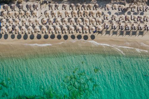 an aerial view of a beach with umbrellas and the ocean at Aegean Palace in Plaka