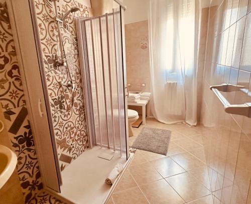 a bathroom with a shower with a toilet and a sink at Domus Angela in Polignano a Mare