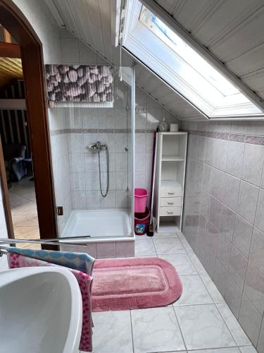 a bathroom with a shower and a tub and a sink at Horváth apartaman in Hévíz