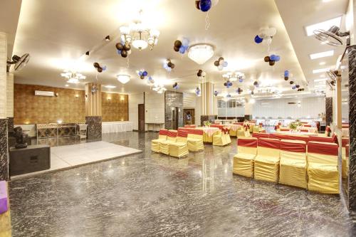a banquet hall with yellow chairs and balloons at Hotel Grand Manor in Gurgaon