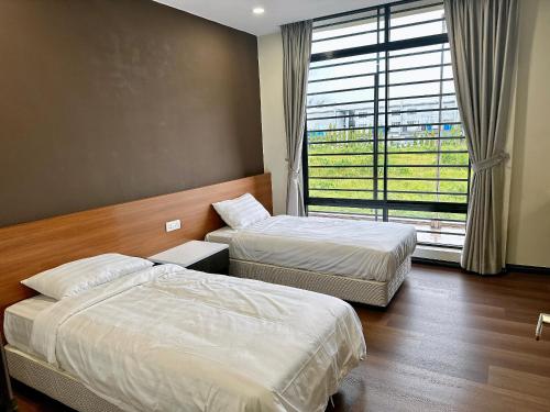 a hotel room with two beds and a window at STAR HOTEL in Tawau