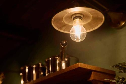 a light hanging from a ceiling with a light bulb at Miki in Osaka