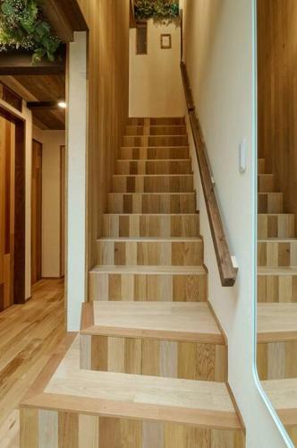 a staircase in a house with wooden floors and a stair case at Miki in Osaka