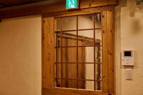 a window in a wall with a sign on it at Miki in Osaka