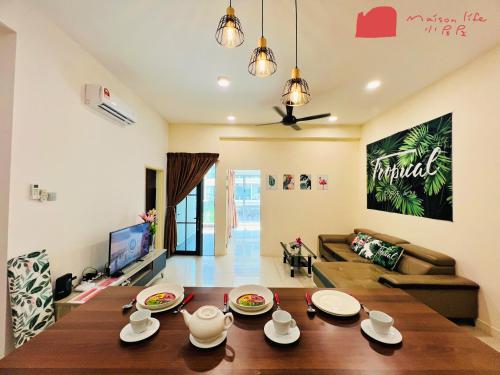 a living room with a table and a couch at Maison life 小居屋 The Loft Imago in Kota Kinabalu