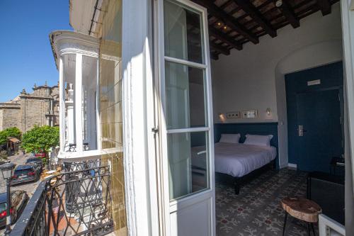Postel nebo postele na pokoji v ubytování Apartahotel Siglo XIX