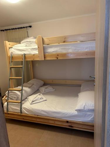 a couple of bunk beds in a room at Kaliopi HAUS in Nea Moudania