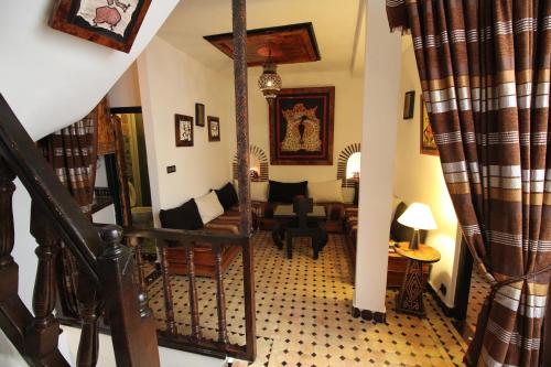a room with a staircase and a living room at Riad Bab Essaouira in Essaouira
