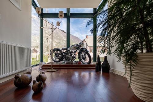 a motorcycle on display in a room with windows at Boutique Hotel Dobra Vila Bovec in Bovec