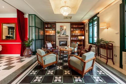 a lobby with chairs and a table and a fireplace at Boutique Hotel Dobra Vila Bovec in Bovec