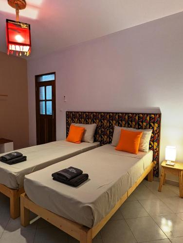 two beds sitting next to each other in a room at Apartment Funana Tarrafal in Tarrafal