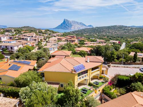 a city with solar panels on the roofs of houses at Hotel Lu Pitrali in San Teodoro