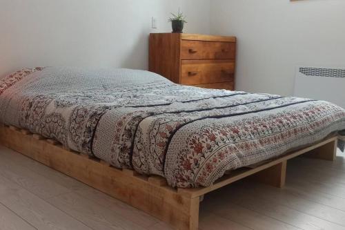 a bed in a room with a dresser and a bed sidx sidx at The House On The Lake in Ferme-Neuve