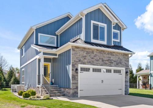 a blue house with a garage at Barefoot Retreat in Winchester