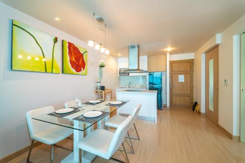 a kitchen and dining room with a table and chairs at Patong Kalim Unparalleled Sea View B&B Resort in Patong Beach
